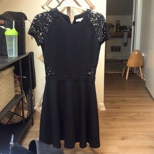 Parker black dress with lace accents.